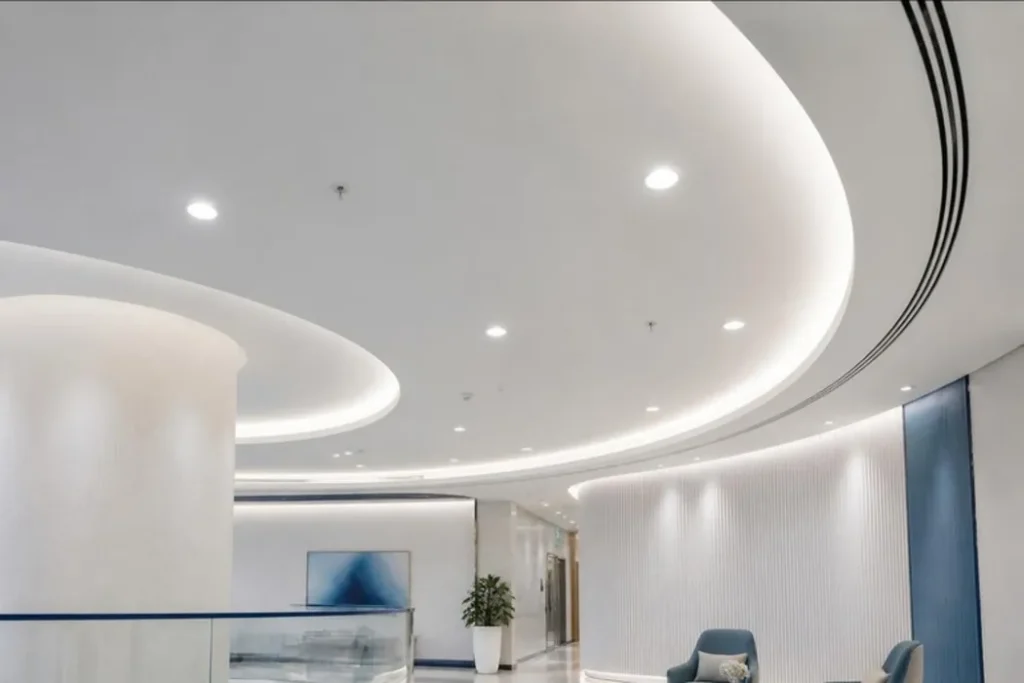 Finished curved gypsum ceiling with cove lighting in a UAE reception
